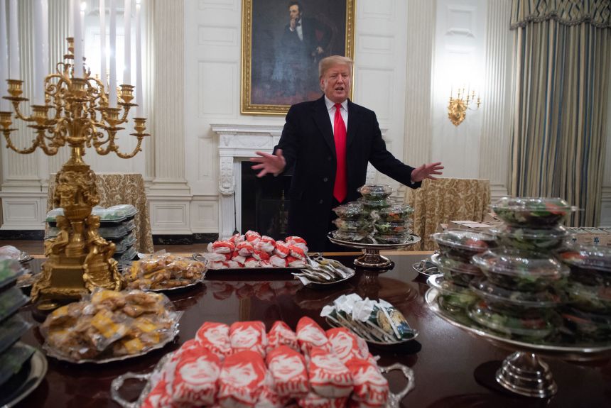 President Donald Trump speaks alongside fast food he purchased for a ceremony honoring the 2018 College Football Playoff National Champion Clemson Tigers, in the State Dining Room of the White House on January 14, 2019, when the White House chefs were furloughed due to the partial government shutdown.