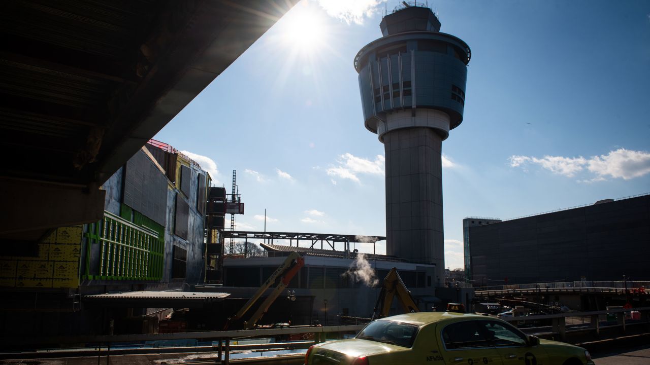 A taxi passes in front of the air traffic control tower at LaGuardia Airport (LGA) in the Queens borough of New York, U.S., on Friday, Jan. 25, 2019. The Federal Aviation Administration temporarily halted flights into New York's LaGuardia Airport because of a shortage of air-traffic control staff, escalating the pressure on President Donald Trump and lawmakers to end the governmentÂ shutdown. Photographer: Mark Kauzlarich/Bloomberg via Getty Images
