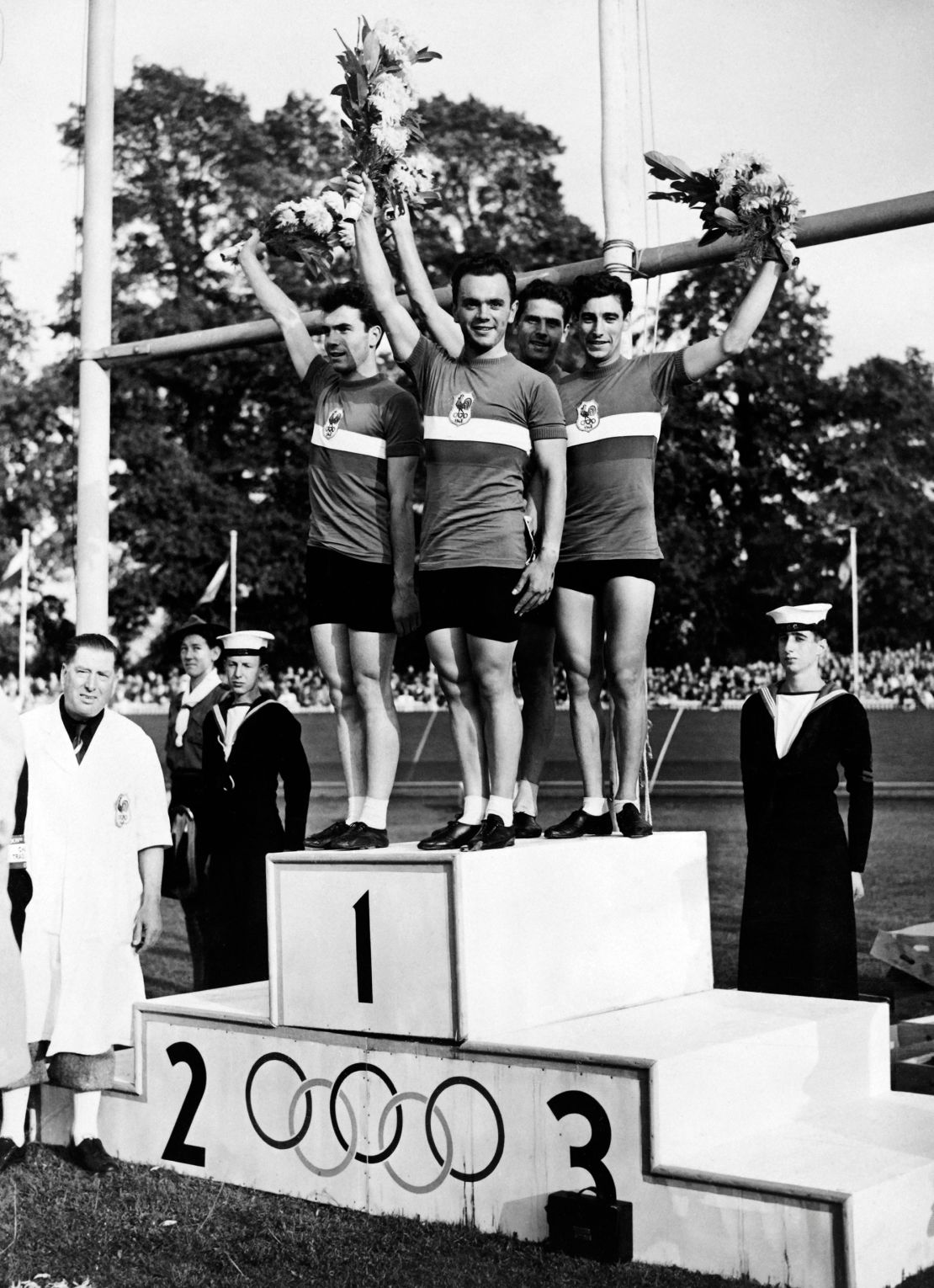 Fernand Decanali, Pierre Adam, Serge Blusson and Charles Coste stand atop the podium at the 1948 Olympics.