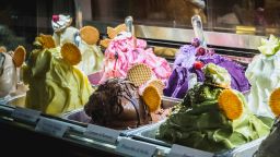 Milan, Italy - November 2, 2017: Showcase of an Italian ice cream shop in historic downtown at night on a fall day