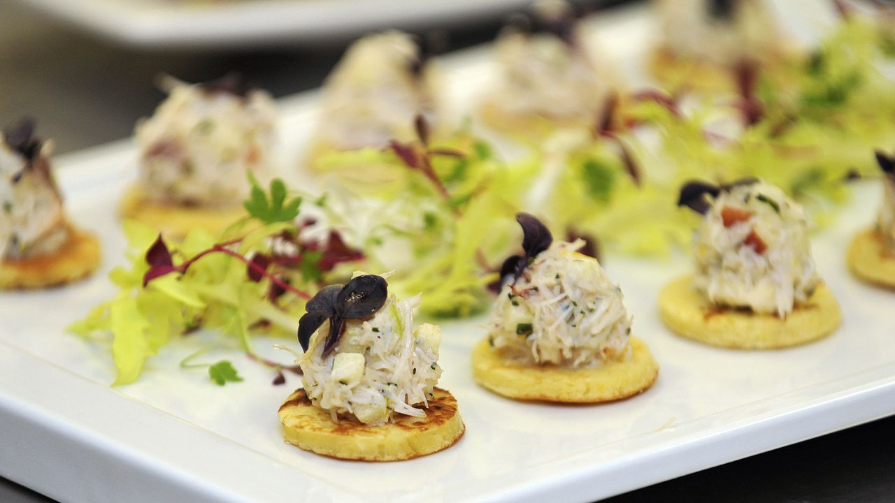 LONDON, UNITED KINGDOM - MARCH 25:  A tray of Cornish Crab and Apple with Lemon Blini canapes, akin to those usually served during royal receptions after they were prepared by the royal chefs in the kitchens at Buckingham Palace on March 25, 2011 in London, England. Prince Prince William will marry his long term girlfriend Kate Middleton on April 29, 2011 at Westminster Abbey and it was reported that the couple had chosen two Wedding cakes for their big day - a 'multi-tiered traditional fruit case with a floral design and a chocolate biscuit cake.'  (Photo by Nick Ansell - WPA Pool/Getty Images)