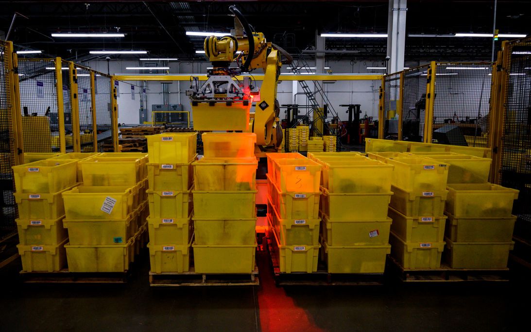 A robot organizes containers at a 855,000-square-foot Amazon fulfillment center in Staten Island, New York City. The onset of AI-induced automation will wipe out many jobs and force people to rethink the notion that a person is not valuable if they don’t have a job, Bregman says.