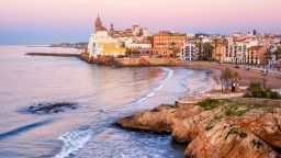 Sand beach and historical Old Town in mediterranean resort Sitges near Barcelona, Costa Dorada, Catalonia, Spain