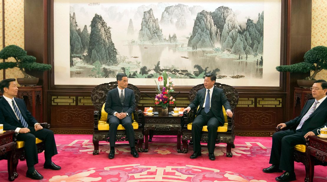 A meeting with former Hong Kong Chief Executive Leung Chun-ying and Chinese leader Xi Jinping in Zhongnanhai on December 26, 2014, a large landscape painting in the background.