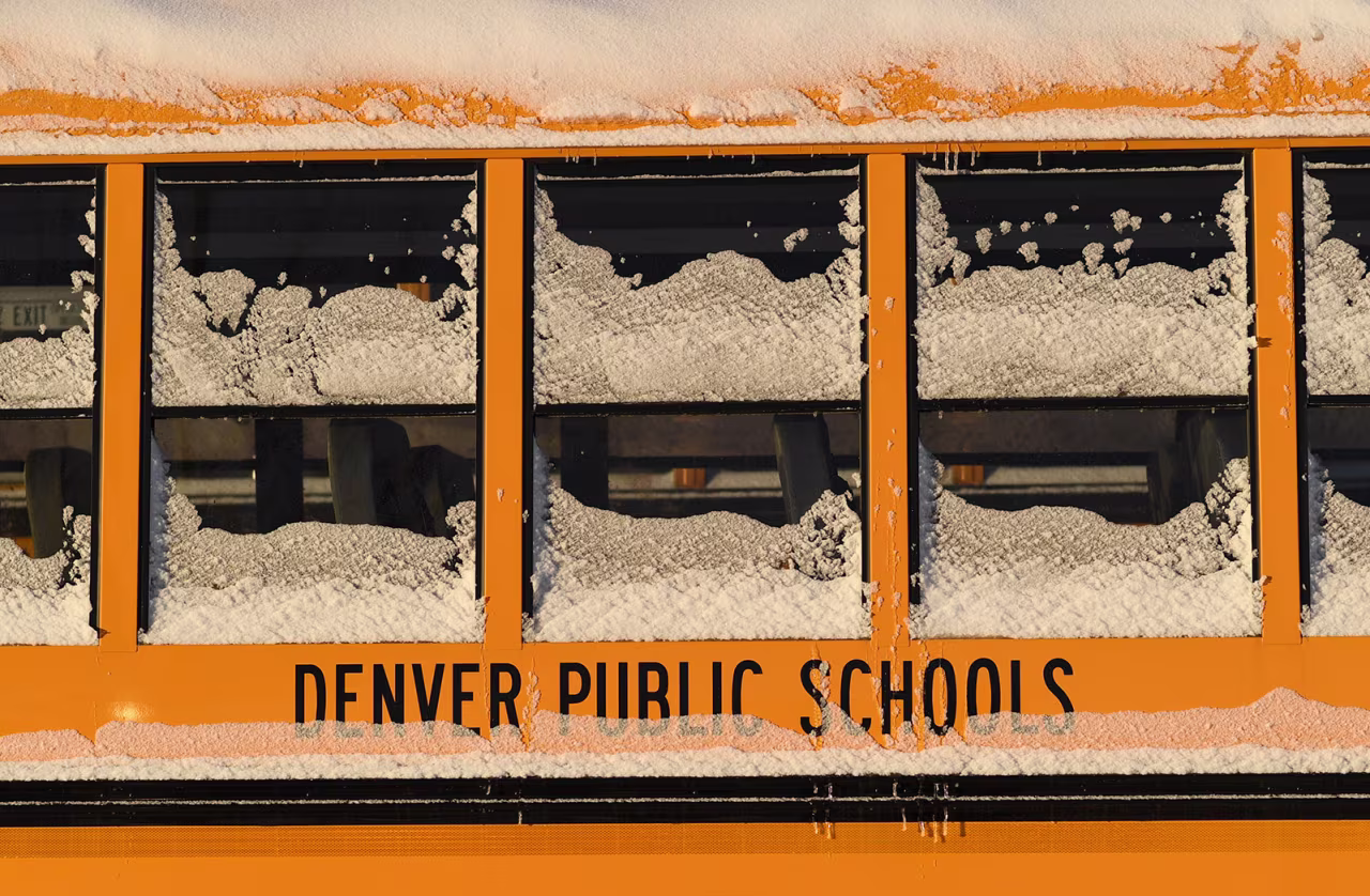 A Denver Public School bus is covered in ice and snow at a bus yard on February 7, 2019 in Denver, Colorado.