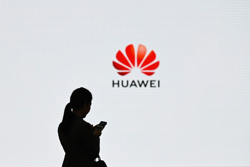 A staff member of Huawei uses her mobile phone at the Huawei Digital Transformation Showcase in Shenzhen, China's Guangdong province on March 6, 2019.
