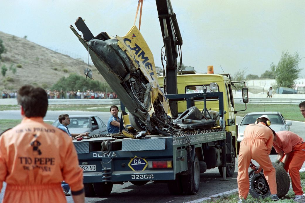 Track marshals clear the remains of Martin Donnelly's Lotus after his accident during a practice session of the Spanish F1 Grand Prix on September 28, 1990.