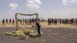 A mourner lays flowers at the Memorial Arch during a visit to the crash site of Ethiopian Airlines 737 Max flight that crashed on March 14, 2019.