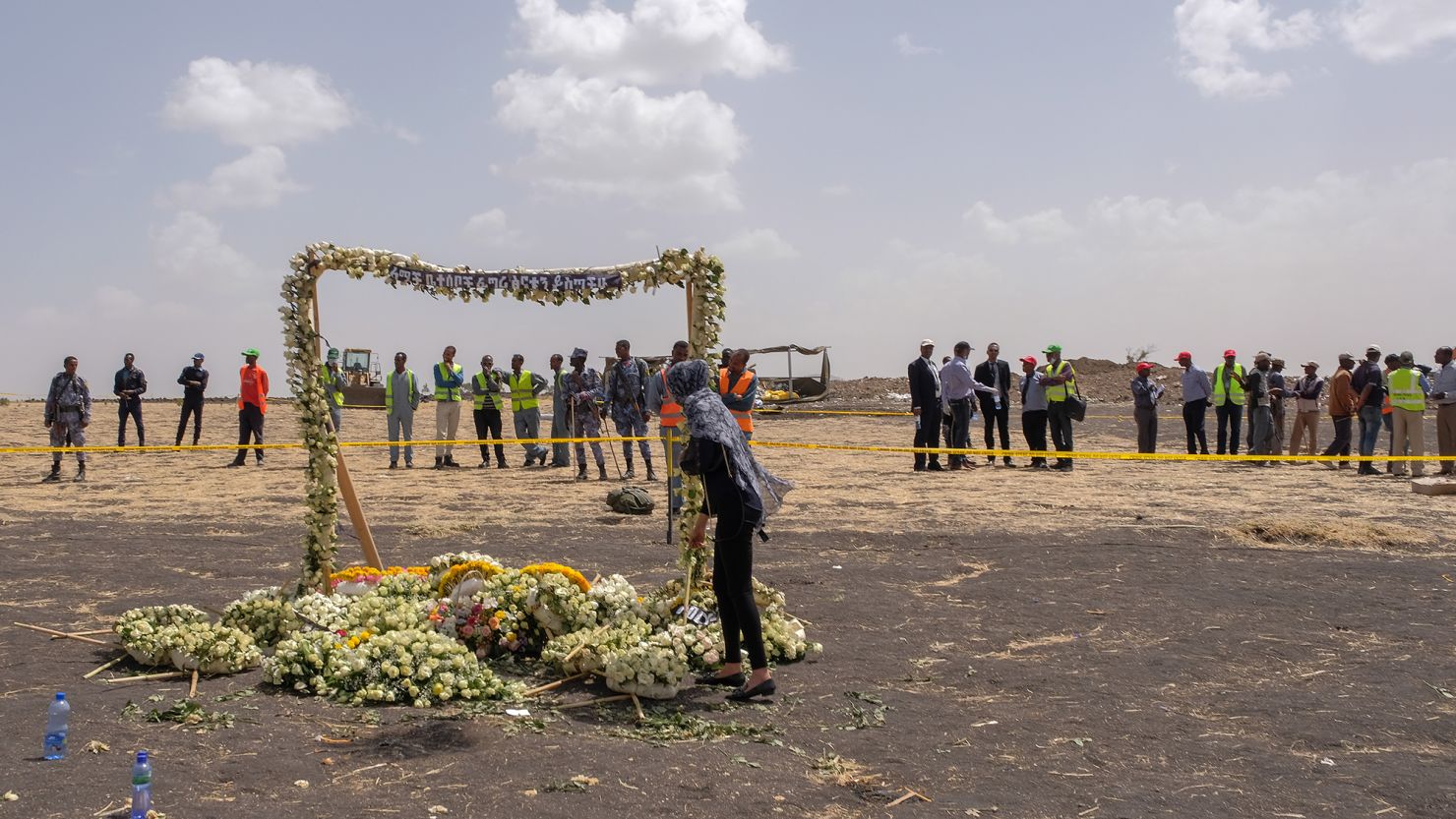 A mourner lays flowers at the Memorial Arch during a visit to the crash site of Ethiopian Airlines 737 Max flight that crashed on March 14, 2019.