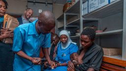 A Health Surveillance Assistant prepares to give a dose of the Malaria Vaccine to a recipient child at Mitundu Community hospital in Malawi's capital district of Lilongwe on the first day of the Malaria vaccine implementation pilot program in Malawi aiming to immunize 120,000 children, on April 23, 2019.