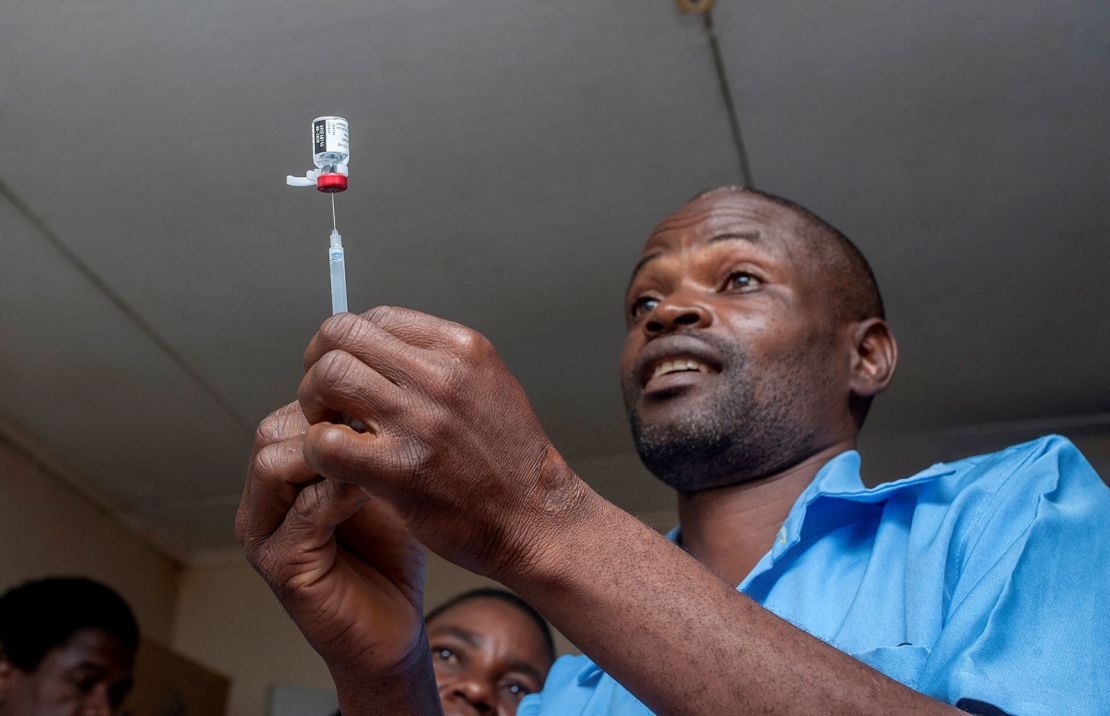 A health worker prepares a malaria vaccine injection to be administered to a child in Malawi's capital district of Lilongwe, in April 2019.