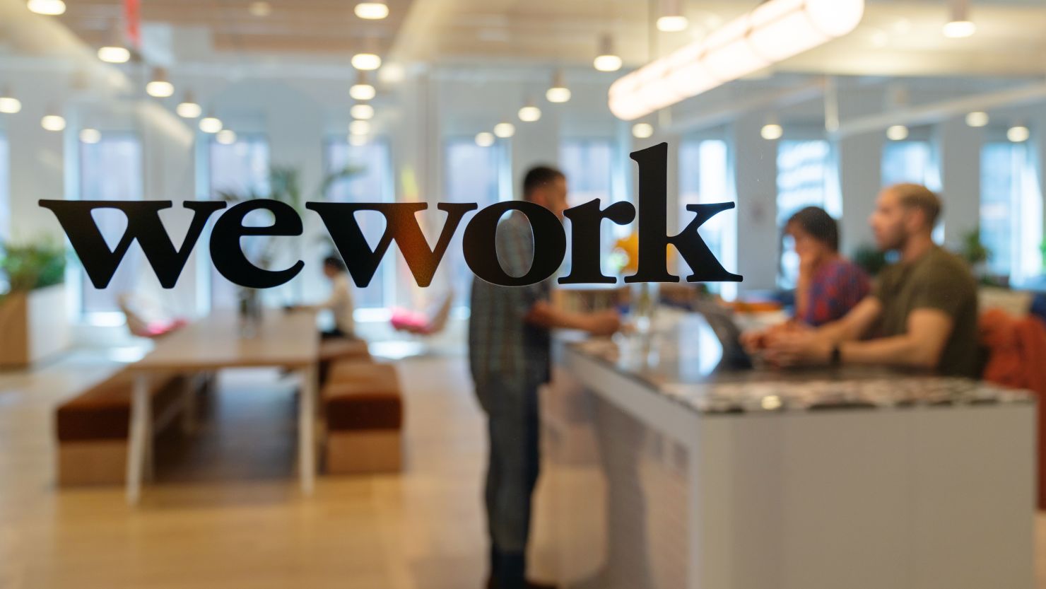 Signage is seen at the entrance of the WeWork Cos Inc. 85 Broad Street offices in the Manhattan borough of New York, U.S., on Wednesday, May 22, 2019.