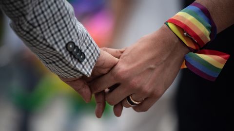A same-sex couple hold hands during an event to raise awareness of gay rights in Hong Kong on May 25, 2019.