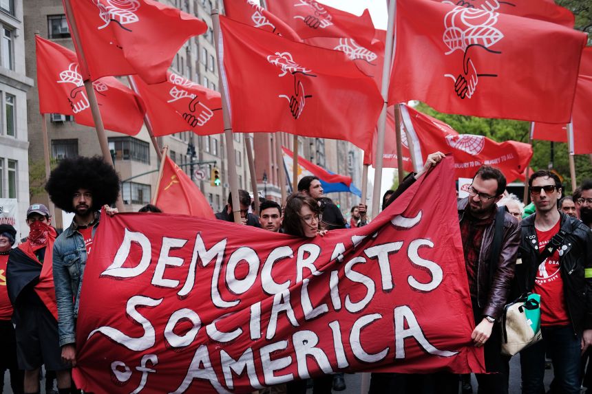 Members of the Democratic Socialists of America demonstrate outside of a Donald Trump-owned building in New York, on May 01, 2019.