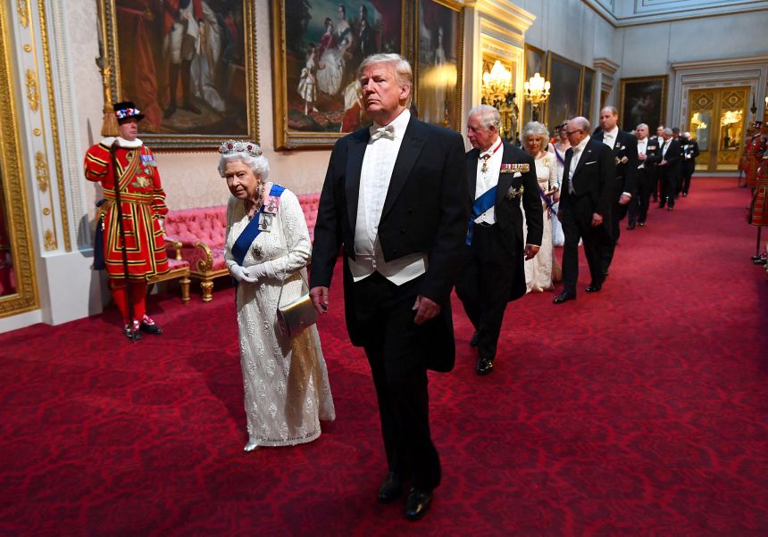 The late Queen Elizabeth II walks with President Donald Trump at a state banquet in Buckingham Palace during the president's visit to London in 2019.