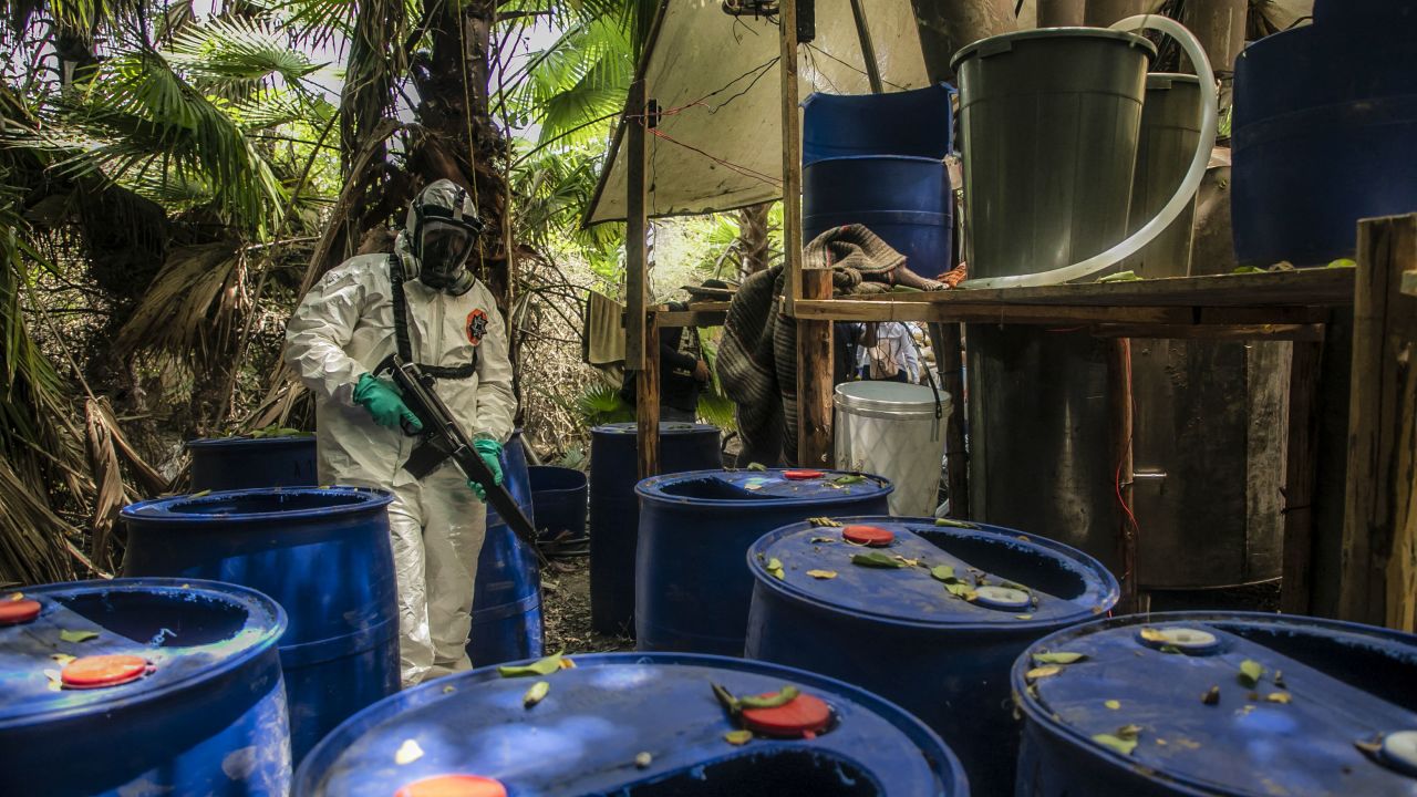 TOPSHOT - A Sinaloa's state police officer works during the dismantle of one of the three clandestine laboratories producers of synthetic drug, mainly methamphetamine in El Dorado, Sinaloa state, Mexico on June 4, 2019. (Photo by RASHIDE FRIAS / AFP) (Photo by RASHIDE FRIAS/AFP via Getty Images)