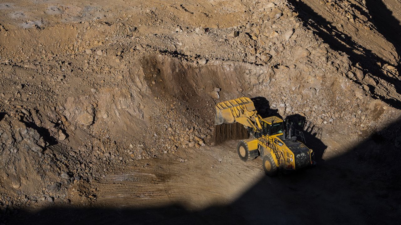 A wheel loader moves raw ore inside the pit at the Mountain Pass mine, operated by MP Materials, in Mountain Pass, California.