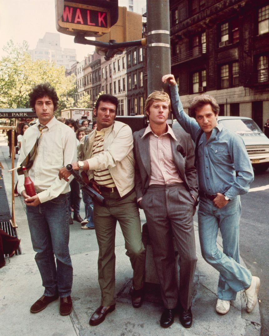 Redford was no stranger to a tailored suit, either. In fact, some of his best looks were built from classic, well-fitting slacks and a sports jacket — shown here with a '70s style wide collar. From left to right, actors Paul Sand, Ron Leibman, Robert Redford and George Segal on set for