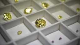 A display of diamonds shows coloured, fancy brownish greenish yellow oval diamond, 50,21 carats (C), among other stones at Alrosa Diamond Cutting Division in Moscow on July 3, 2019. - Russian Alrosa gets its diamonds in the permafrost abyssal holes dug with explosives in the permanently frozen ground of Yakutia, an isolated region in East Siberia, the home to the huge diamond deposits that ensure Russia's supremacy in world production. (Photo by Alexander NEMENOV / AFP)        (Photo credit should read ALEXANDER NEMENOV/AFP via Getty Images)
