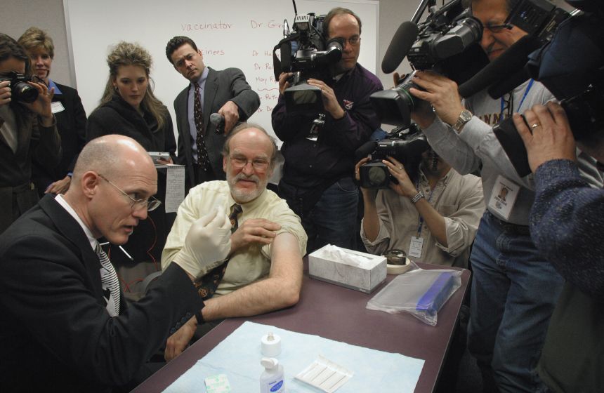 Dr. Greg Poland, left, of the Mayo Clinic vaccinates Dr. Harry Hall against smallpox during a demonstration in St. Paul, Minnesota, in 2003.