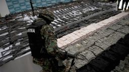 A Mexican marine stands in front of different kinds of firearms, cocaine and military uniforms seized to alleged members of the Zetas drug traffickers cartel and presented to press on June 9, 2011 at the Navy Secretaryship in Mexico City. Fiven men were arrested and more than two hundred rifles, eleven pistols, military uniforms, differents caliber ammunitions and more than 200 kg of cocaine were seized in the Coahuila and Nuevo Leon States by the Navy. AFP PHOTO/ Yuri CORTEZ (Photo credit should read YURI CORTEZ/AFP via Getty Images)