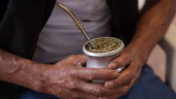 MONTECARLO, ARGENTINA - AUGUST 27: A rural worker holds an infusion of 'Mate' with his hands in the Yerba Mate Trade Union Workers as part of the production of the Yerba Mate herb in the Argentine northeastern province of Misiones on August 27, 2015 in Montecarlo, Argentina. The Yerba mate herb is used in central and southern regions of South America as a traditional beverage known as 'mate' in Spanish-speaking countries or chimarrÃ£o in Brazil. (Photo by Ricardo Ceppi/Getty Images)