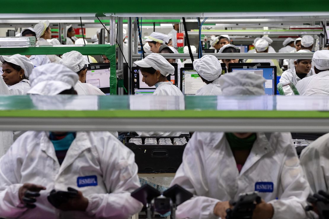 Employees test mobile phones on an assembly line of a unit of Foxconn Technology in Sriperumbudur, Tamil Nadu, on July 12, 2019.