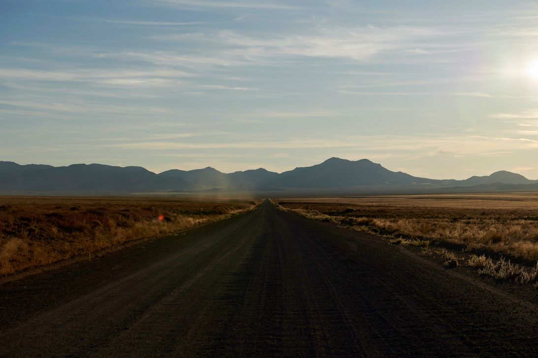 A long, desolate dirt road leads to a gate of the Nevada Test and Training Range, commonly referred to as Area 51. More purported UFO sightings occur in nearby Rachel, Nevada, each year than in any other place in the US.