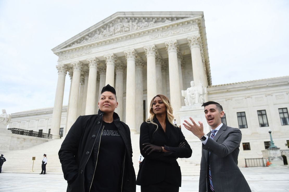 Actresses Laverne Cox, center, and Sara Ramirez and attorney Chase Strangio, right, pose in 2019 as pro-LGBTQ+ rights demonstrators rally outside the US Supreme Court in Washington, DC.