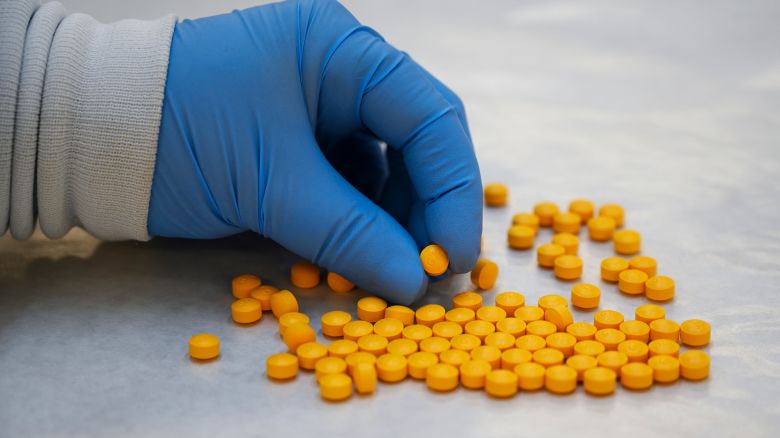 CORRECTION / A Drug Enforcement Administration (DEA) chemist checks tablets believed to be laced with fentanyl at the DEA Northeast Regional Laboratory on October 8, 2019 in New York. According to US government data, about 32,000 Americans died from opioid overdoses in 2018. That accounts for 46 percent of all fatal overdoses. Fentanyl, a powerful painkiller approved by the US Food and Drug Administration for a range of conditions, has been central to the American opioid crisis which began in the late 1990s. (Photo by Don EMMERT / AFP) / "The erroneous mention[s] appearing in the metadata of this photo by Don EMMERT has been modified in AFP systems in the following manner: [tablets believed to be laced with fentanyl] instead of [confiscated powder containing fentanyl]. Please immediately remove the erroneous mention[s] from all your online services and delete it (them) from your servers. If you have been authorized by AFP to distribute it (them) to third parties, please ensure that the same actions are carried out by them. Failure to promptly comply with these instructions will entail liability on your part for any continued or post notification usage. Therefore we thank you very much for all your attention and prompt action. We are sorry for the inconvenience this notification may cause and remain at your disposal for any further information you may require." (Photo by DON EMMERT/AFP via Getty Images)          
