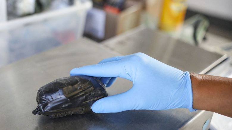 A US Customs and Border Protection agent weighs a package of Fentanyl at the San Ysidro Port of Entry in San Ysidro, California on October 2, 2019.