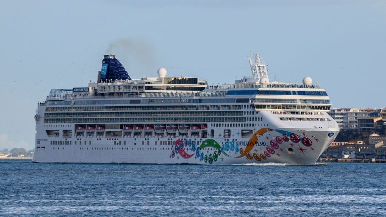 LISBON, PORTUGAL - OCTOBER 20: Norwegian Pearl, a Jewel class cruise ship of Norwegian Cruise Line, sails the Tagus River under 25 de Abril Bridge while leaving harbor on her way to Ponta Delgada, in the Azores, at the end of the afternoon on October 20, 2019 in Lisbon, Portugal. Norwegian Pearl is the third of NCL's four Jewel-class ships. She was preceded by Norwegian Jewel in 2005, and Pride of Hawaii (now Norwegian Jade) in 2006. She was followed by Norwegian Gem in 2007. (Photo by Horacio Villalobos#Corbis/Corbis via Getty Images)