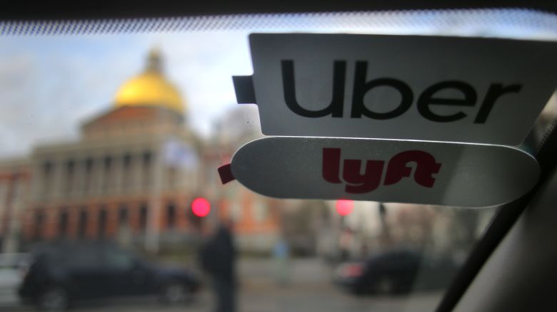 Uber and Lyft stickers are pictured inside a ride share vehicle outside the Massachusetts State House in Boston on Nov. 14, 2019.