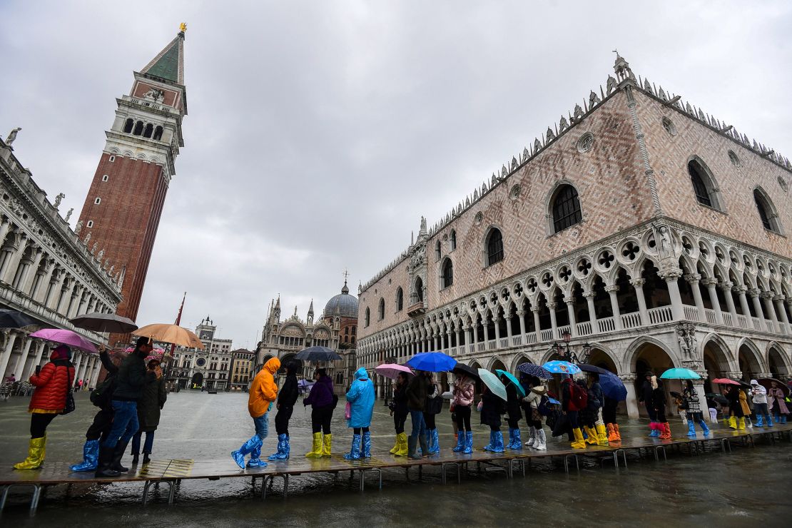 Tourists enjoy splashing through the streets but high tides are devastating for the city.