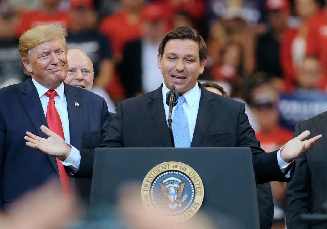 President Donald Trump looks on as Florida Governor Ron DeSantis speaks during the Florida Homecoming rally at the BB&T Center in 2019.