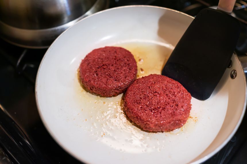 Faux sausages carry the red appearance of meat and sizzle in the pan.