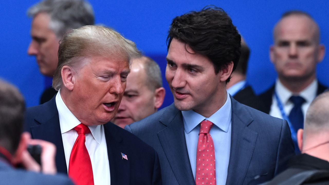 US President Donald Trump (L) talks with Canada's Prime Minister Justin Trudeau during the plenary session of the NATO summit at the Grove hotel in Watford, northeast of London on December 4, 2019.