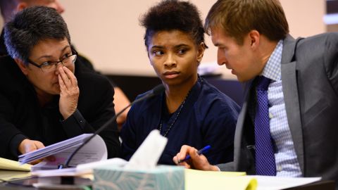 KENOSHA, WISCONSIN - NOVEMBER 13: Chrystul Kizer is pictured during a hearing in the Kenosha County Courthouse on November 15, 2019. Her lawyers, public defenders Larisa Vargas Benitez-Morgan, left, and Carl Johnson talk during the hearing. Kizer was 16 years old when she met Randal P. Volar III, 33, at a bus stop. He offered to give her a ride home, then got her number. The next time they met, according to Chrystul, he took her to dinner and shopping  then made clear what he expected in return. For two years, Volar regularly engaged in sexual abuse of Chrystul, and without her knowing it, filmed their interactions. Little did she know, Volar was under investigation by local police for abusing and filming many more girls  but they had not yet arrested him. One night, after resisting his advances, Chrystul shot Volar in the head. She lit his house on fire and fled in his car. After posting about the crime on Facebook Live, she was arrested and charged with his murder. Now, her case is at the center of a nationwide debate, taking place in the post Me Too era, about what it means to be a victim, which women are believed, and who should be held accountable. (Photo by Sarah L. Voisin/The Washington Post via Getty Images)