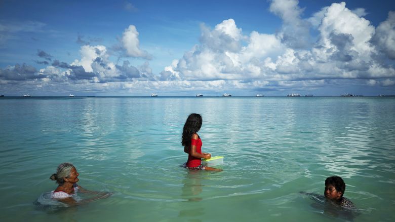 People swim in the lagoon in Funafuti, Tuvalu, on November 28, 2019.