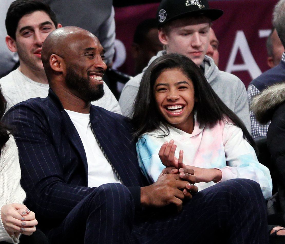 Kobe Bryant and his daughter Gigi watch an NBA game between the Brooklyn Nets and Atlanta Hawks on December 21, 2019.