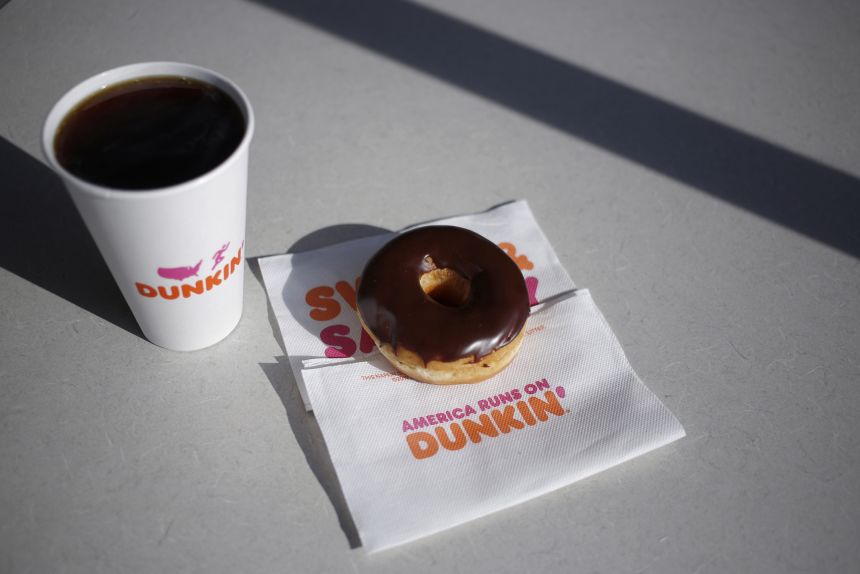 A black coffee and chocolate frosted donut are arranged for a photograph inside a Dunkin' location in Mount Washington, Kentucky, U.S., on Thursday, Jan. 30, 2020.