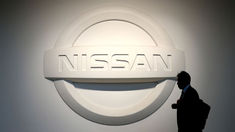 In this February 2020 file photo, a man walks past the logo of Nissan Motor at the company's showroom in Yokohama.