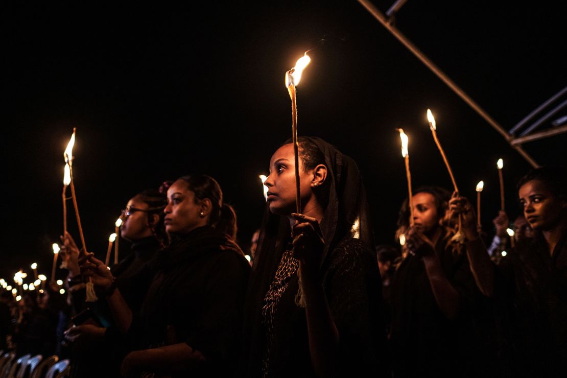 Relatives and colleagues of the Ethiopian Airlines' crew victims hold candles during a commemoration ceremony held by the Airline Pilots' Association of Ethiopia on the first anniversary of the Ethiopian Airlines Flight 302 crash in Addis Ababa, Ethiopia.