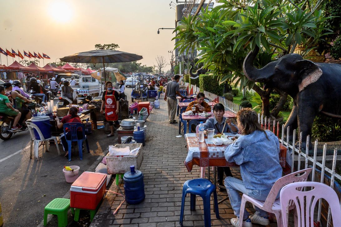 People gather to eat street food in Vientiane.