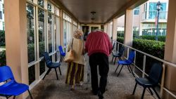 An elderly residents walks inside deserted John Knox Village, a retirement community in Pompano Beach, Florida on March 21, 2020. - Almost one billion people were confined to their homes worldwide as the global coronavirus death toll topped 12,000 and US states rolled out stay-at-home measures already imposed across swathes of Europe. More than a third of Americans were adjusting to life in various phases of virtual lockdown -- including in the US's three biggest cities of New York, Los Angeles and Chicago -- with more states expected to ramp up restrictions. (Photo by CHANDAN KHANNA / AFP) (Photo by CHANDAN KHANNA/AFP via Getty Images)