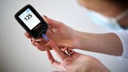 A woman with diabetes uses a glucometer to measure the glycemia in her blood in Paris on March 24, 2020, on the eighth day of a strict lockdown in  aimed at curbing the spread of COVID-19 caused by the novel coronavirus. (Photo by FRANCK FIFE / AFP) (Photo by FRANCK FIFE/AFP via Getty Images)