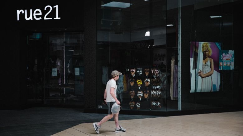 A shopper walks past a closed Rue 21 store in the re-opened Anderson Mall in Anderson, South Carolina, on Friday, April 24, 2020. After rescinding an April 3 executive order, Governor Henry McMaster set the stage for clothing, department, furniture, jewelry and sporting goods stores to reopen their doors to customers.