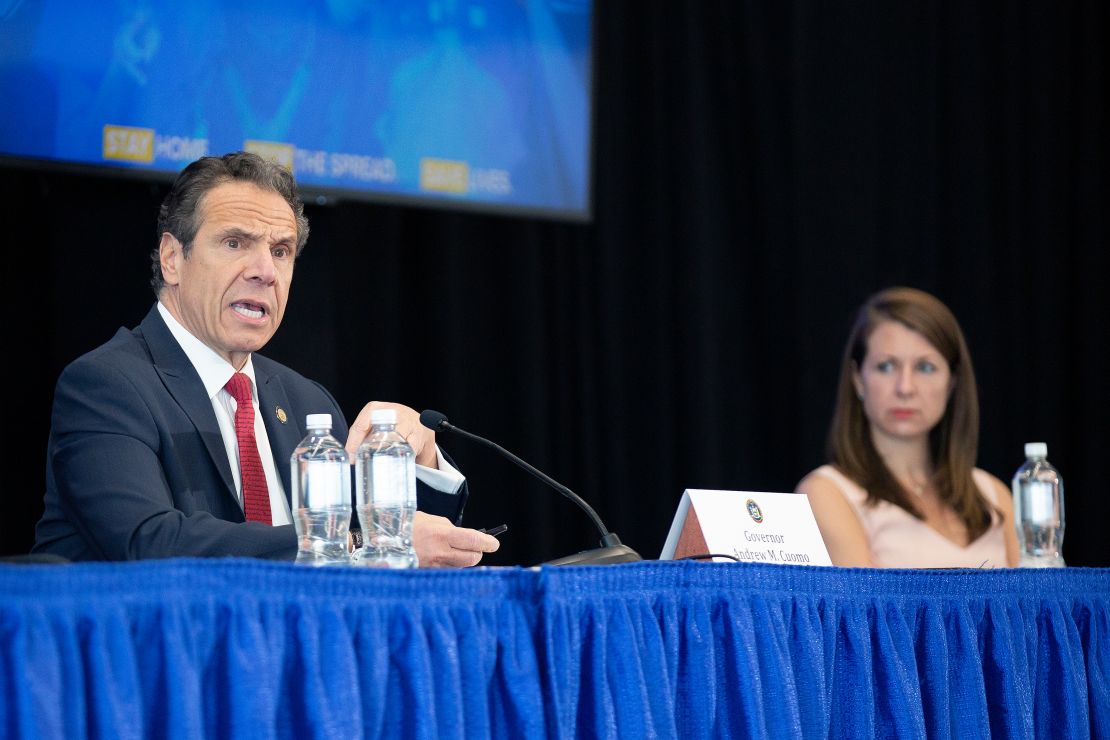 Melissa DeRosa, then the secretary to the governor, right, listens as then-Gov. Cuomo speaks during his daily coronavirus press briefing at SUNY Upstate Medical University on April 28, 2020 in Syracuse, New York.