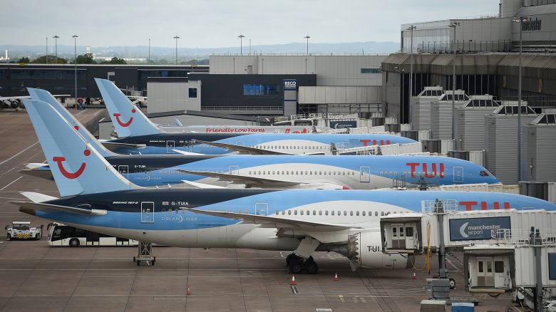 Aircraft grounded due to the COVID-19 pandemic, including planes operated by TUI, are pictured on the apron at Manchester Airport in Manchester, north west England on May 1, 2020.