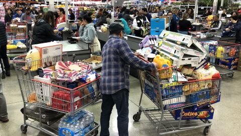 RICHMOND, CALIFORNIA - MARCH 13: A Costco customer stands by his two shopping carts at a Costco store on March 13, 2020 in Richmond, California. Some Americans are stocking up on food, toilet paper, water and other items after the World Health Organization (WHO) declared Coronavirus (COVID-19) a pandemic. (Photo by Justin Sullivan/Getty Images)